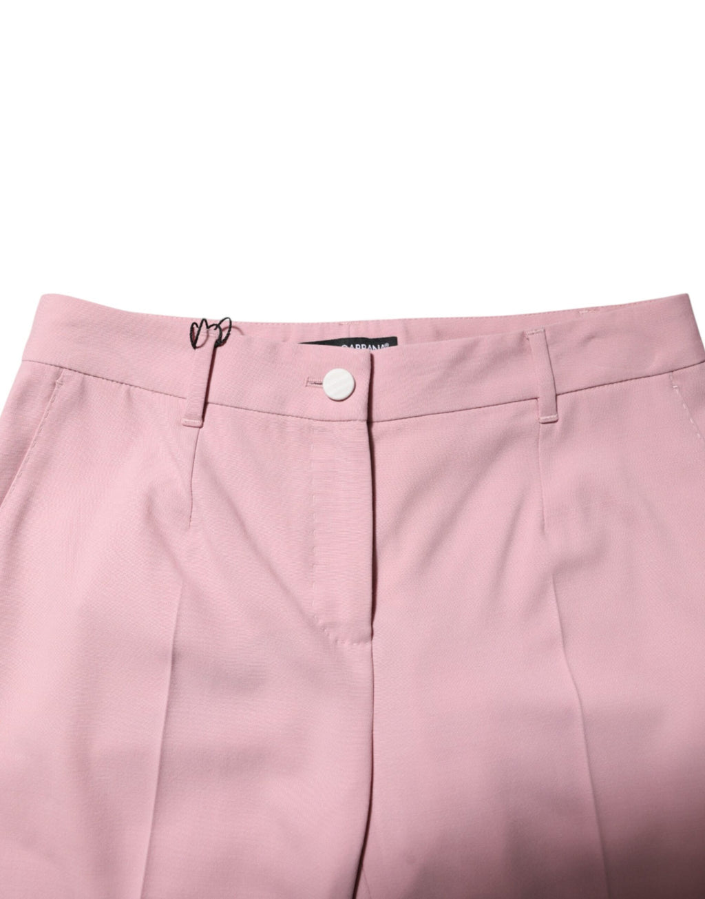 Pantalons en laine rose Dolce & Gabbana, taille mi-haute et coupe tapered, visibles en gros plan sur fond neutre.