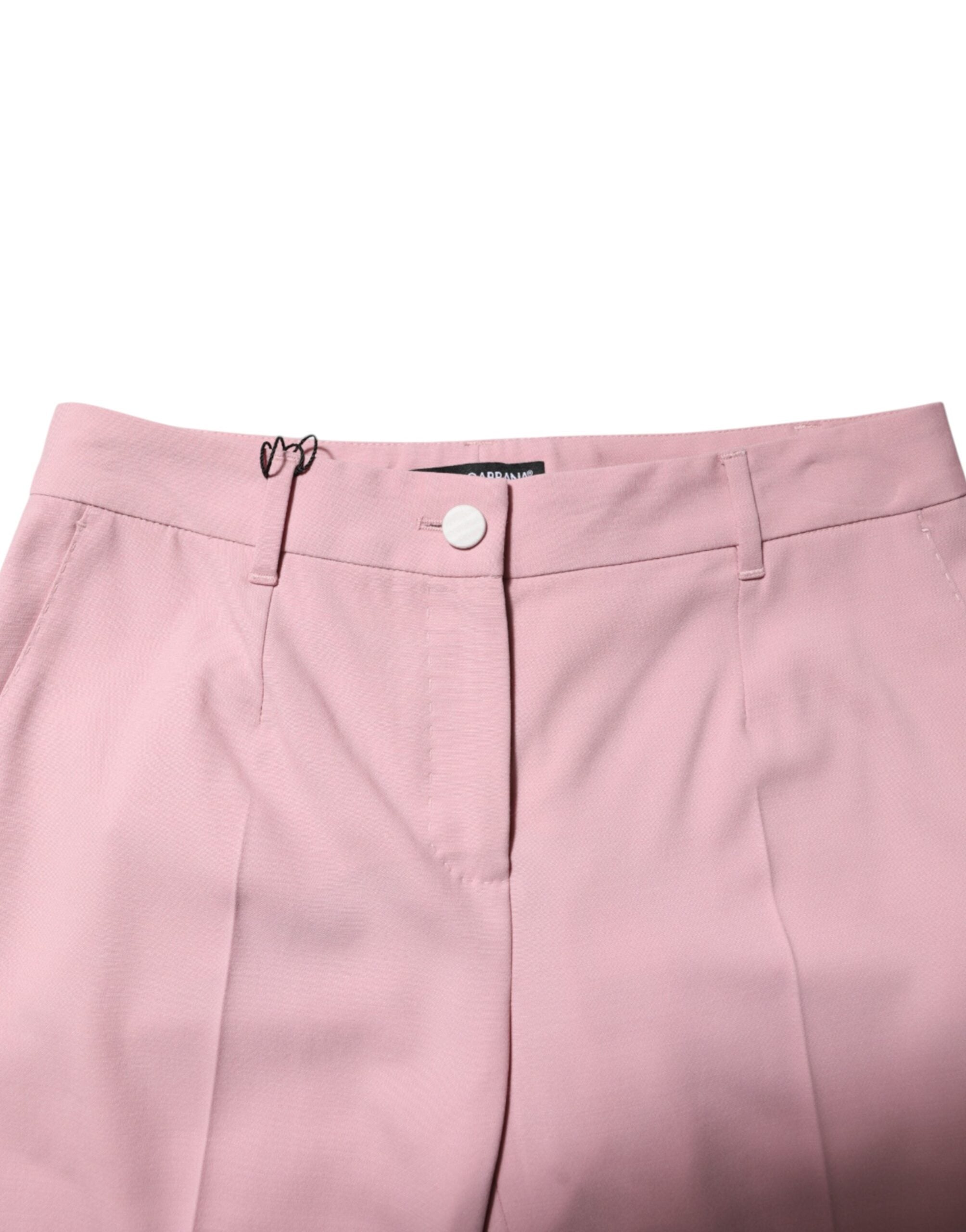 Pantalons en laine rose Dolce & Gabbana, taille mi-haute et coupe tapered, visibles en gros plan sur fond neutre.