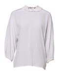 Blouse Dolce & Gabbana blanche à col volanté et détails plissés, vue de face, en tissu léger.