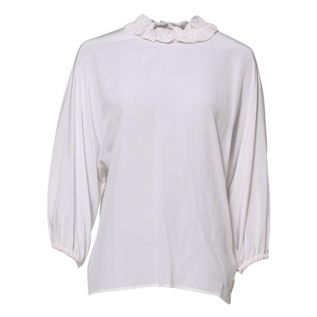 Blouse blanche Dolce & Gabbana à col volanté et manches longues, élégante et féminine, portée sur un mannequin.