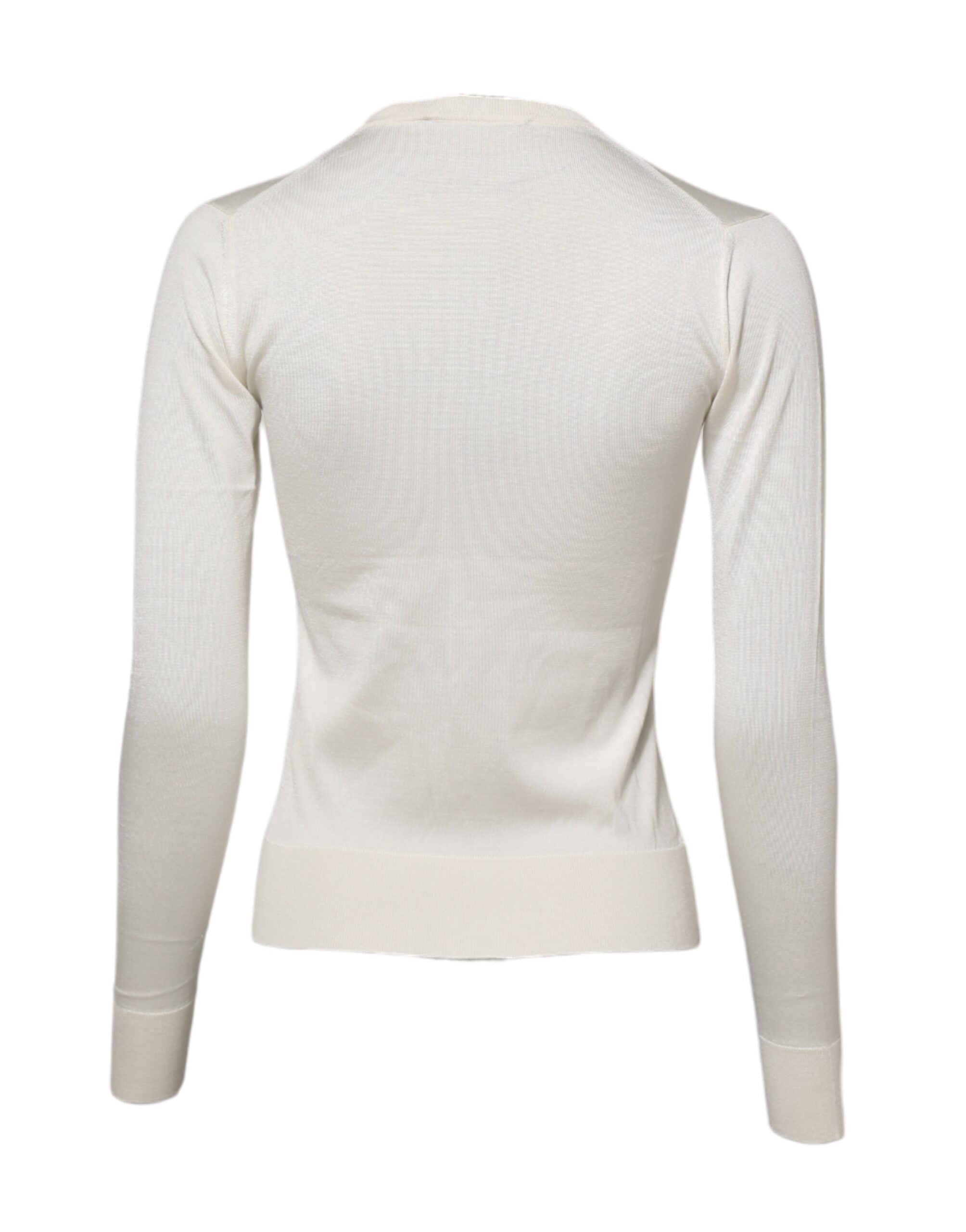 Cardigan Dolce & Gabbana en soie blanche avec broderies de lys, élégante et ornée de détails sophistiqués.