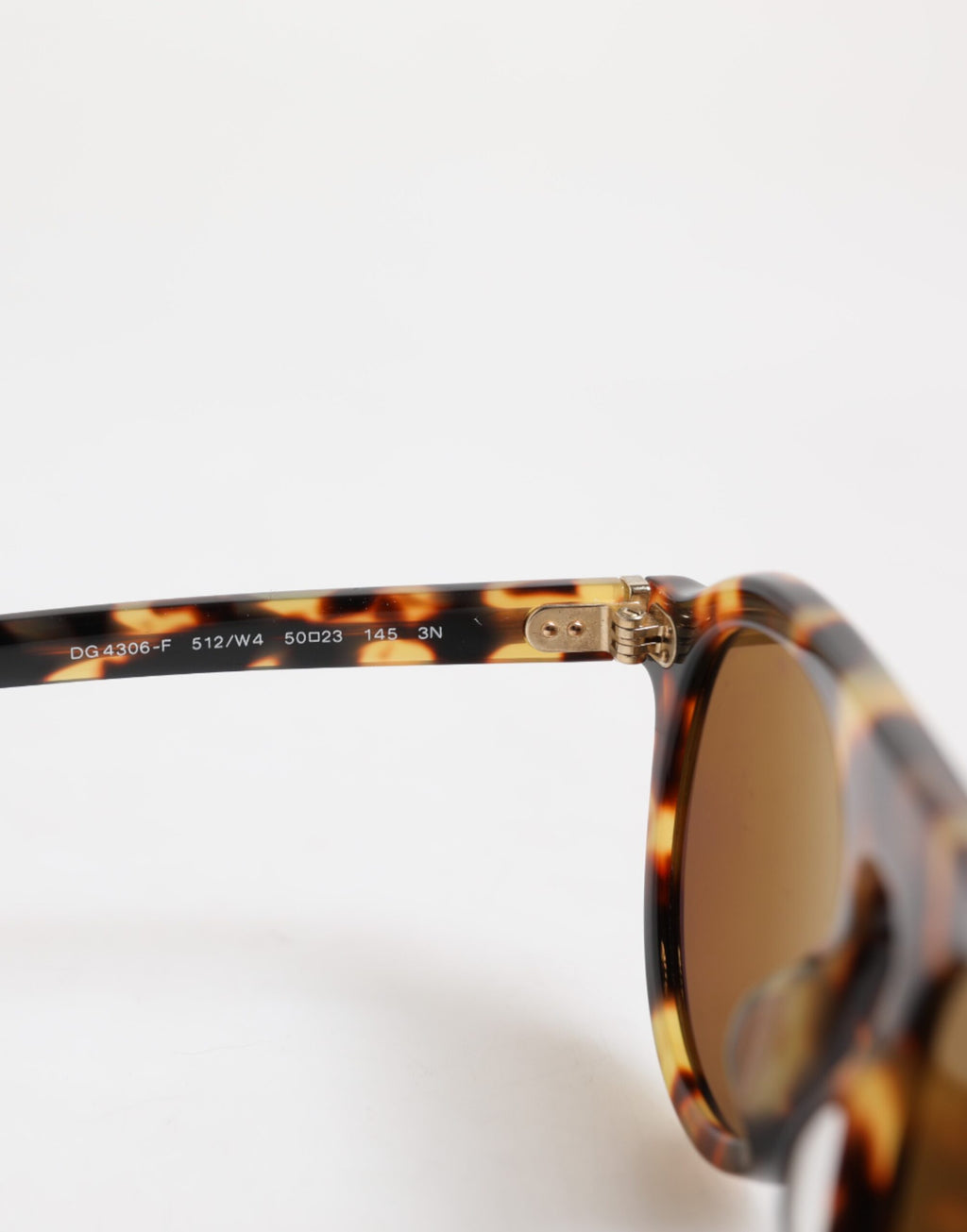 Lunettes de soleil Dolce & Gabbana rondes en acétate marron avec imprimé léopard pour un style élégant.