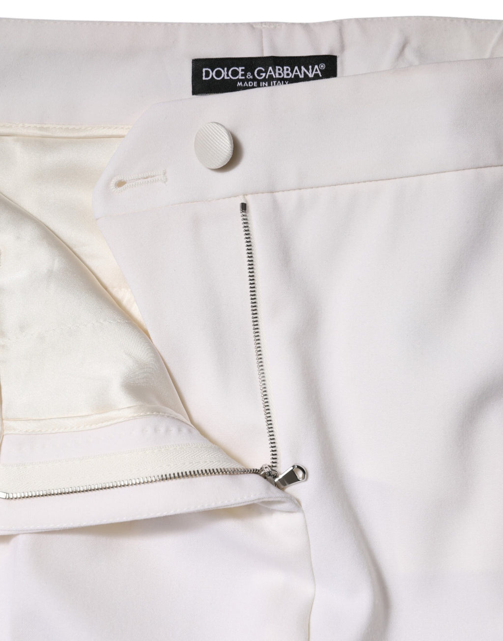 Pantalon en laine blanche Dolce & Gabbana, taille mi-haute, coupe tapered, visible sur l'image.