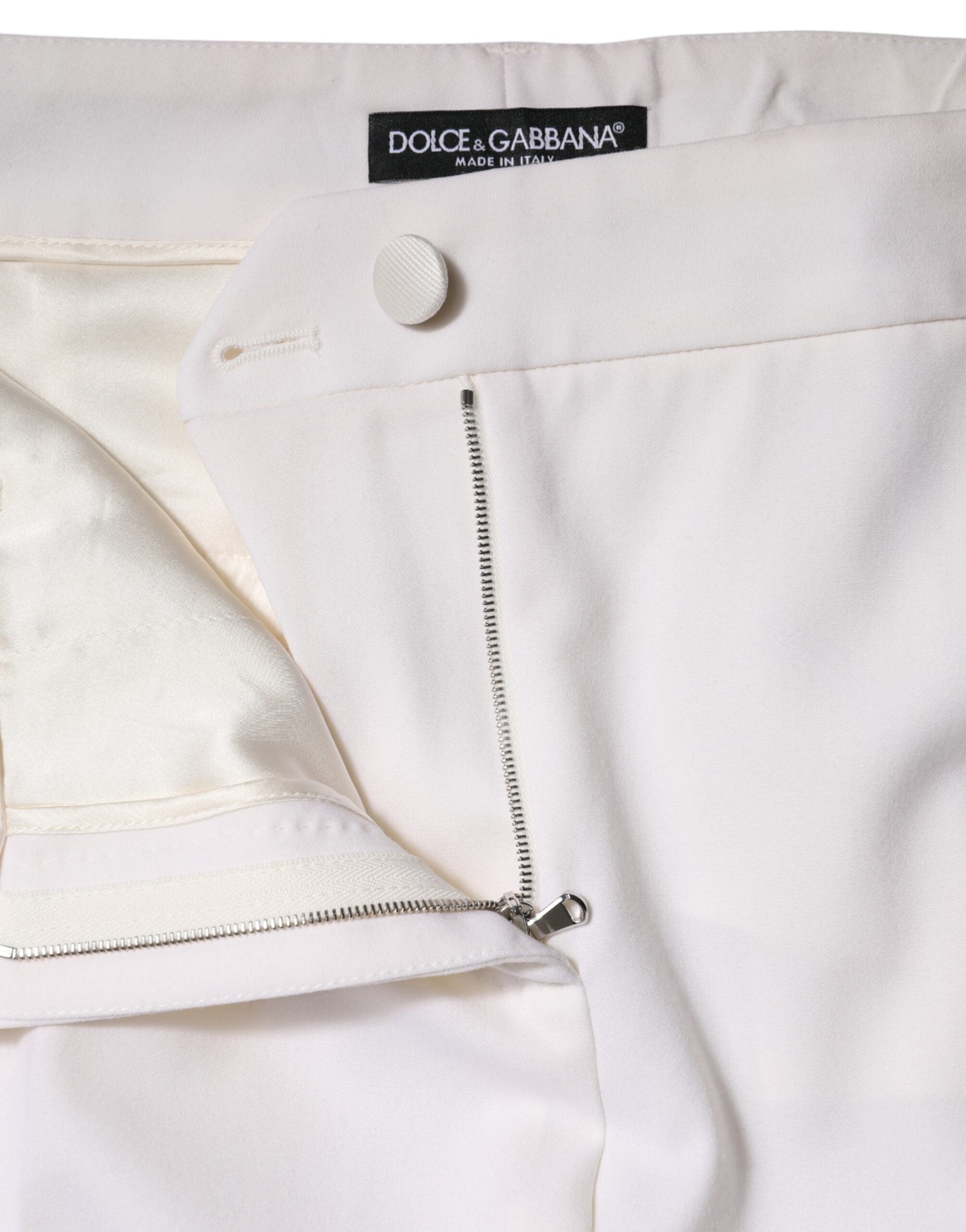 Pantalon en laine blanche Dolce & Gabbana, taille mi-haute, coupe tapered, visible sur l'image.