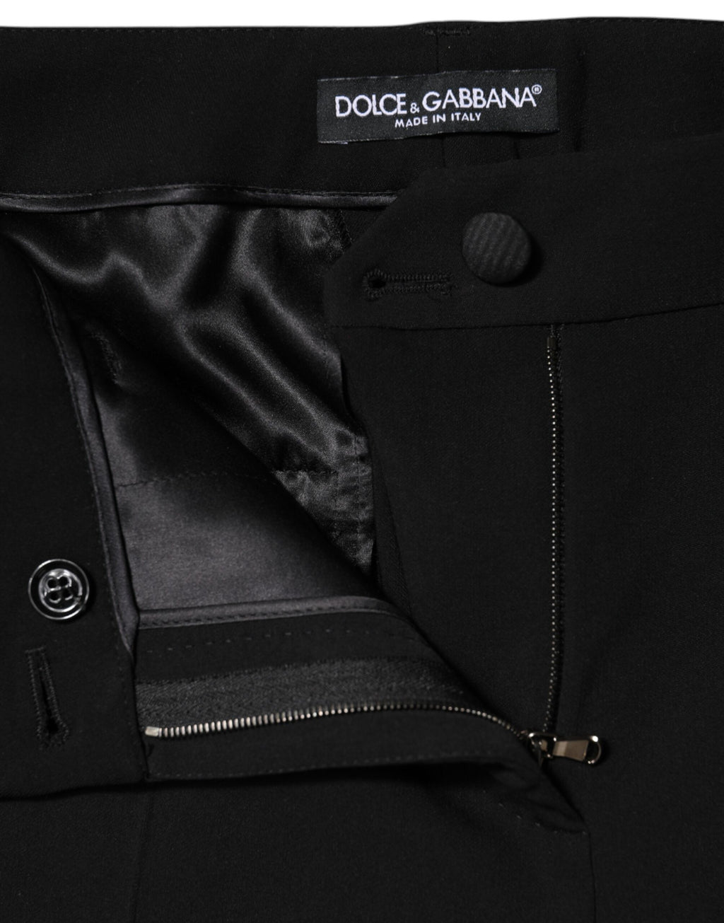 Pantalons noirs en laine à taille haute et coupe tapered de Dolce & Gabbana, visibles sur l'image.