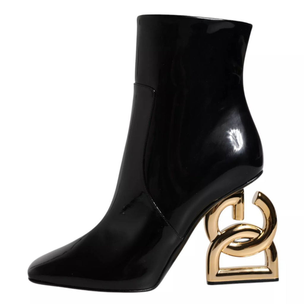 Bottes en cuir noir Dolce & Gabbana Jackie, mi-mollet, style élégant et sophistiqué, visibles en gros plan.