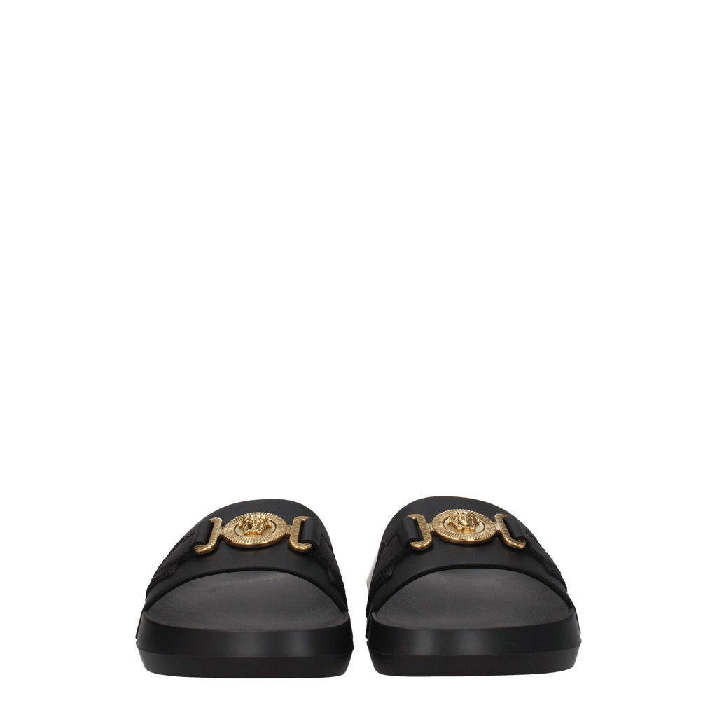 Pantoufles en cuir noir Versace, élégantes et confortables, avec logo distinctif visible sur la surface.