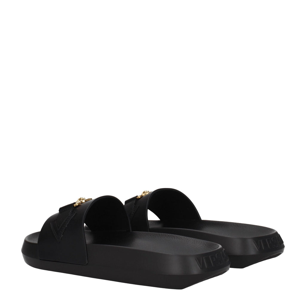 Chaussures de pantoufle en cuir noir Versace, élégantes et confortables, pour homme ou femme, avec logo de la marque visible.