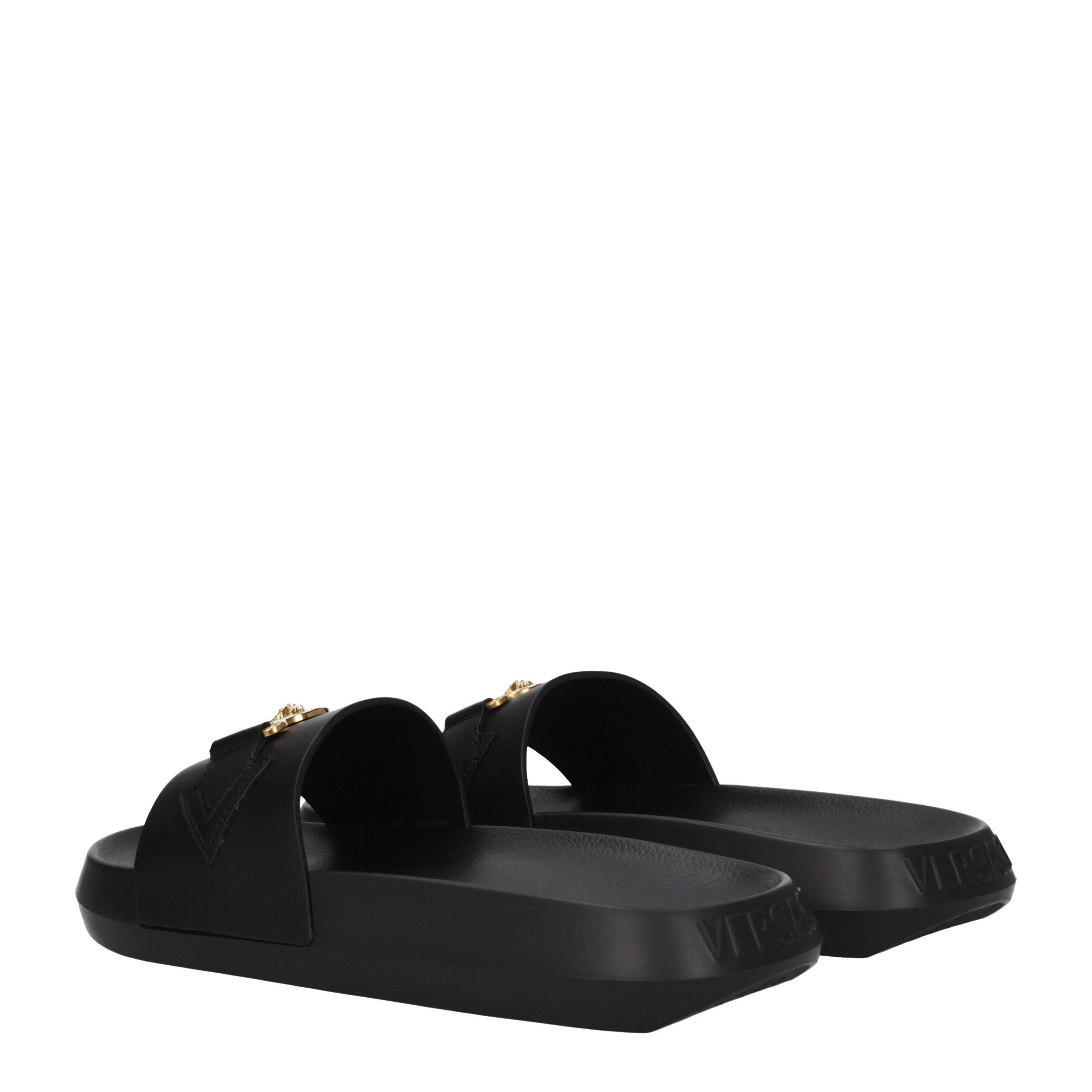Chaussures de pantoufle en cuir noir Versace, élégantes et confortables, pour homme ou femme, avec logo de la marque visible.