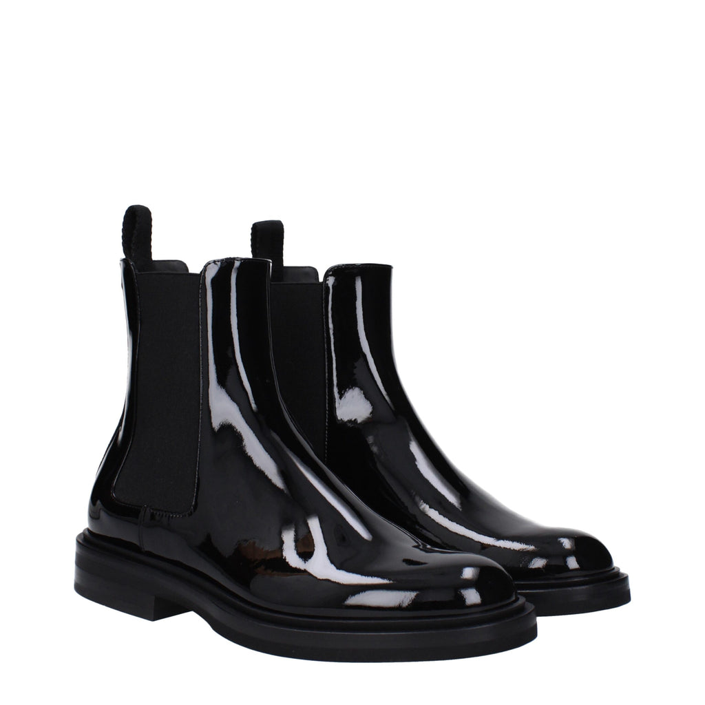 Bottes bottines en cuir noir de la marque Dolce & Gabbana, ankle, avec détails élégants et finition soignée.