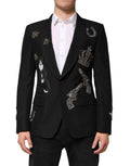 Costume blazer noir Dolce & Gabbana avec motif abeille couronne embellie, élégant et sophistiqué, porté sur un mannequin.
