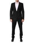 Costume homme Dolce & Gabbana en jacquard noir à deux pièces, veste à simple boutonnage et pantalon élégant.