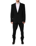 Costume noir en coton Dolce & Gabbana à deux pièces avec veste croisée simple, élégance masculine.