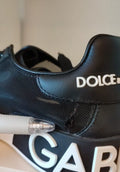 Chaussures Portofino en cuir de veau noir de Dolce & Gabbana, sneakers élégants avec semelle blanche et design moderne.