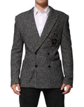 Costume homme Dolce & Gabbana noir et blanc à double boutonnage, blazer élégant avec pochettes et revers classiques.