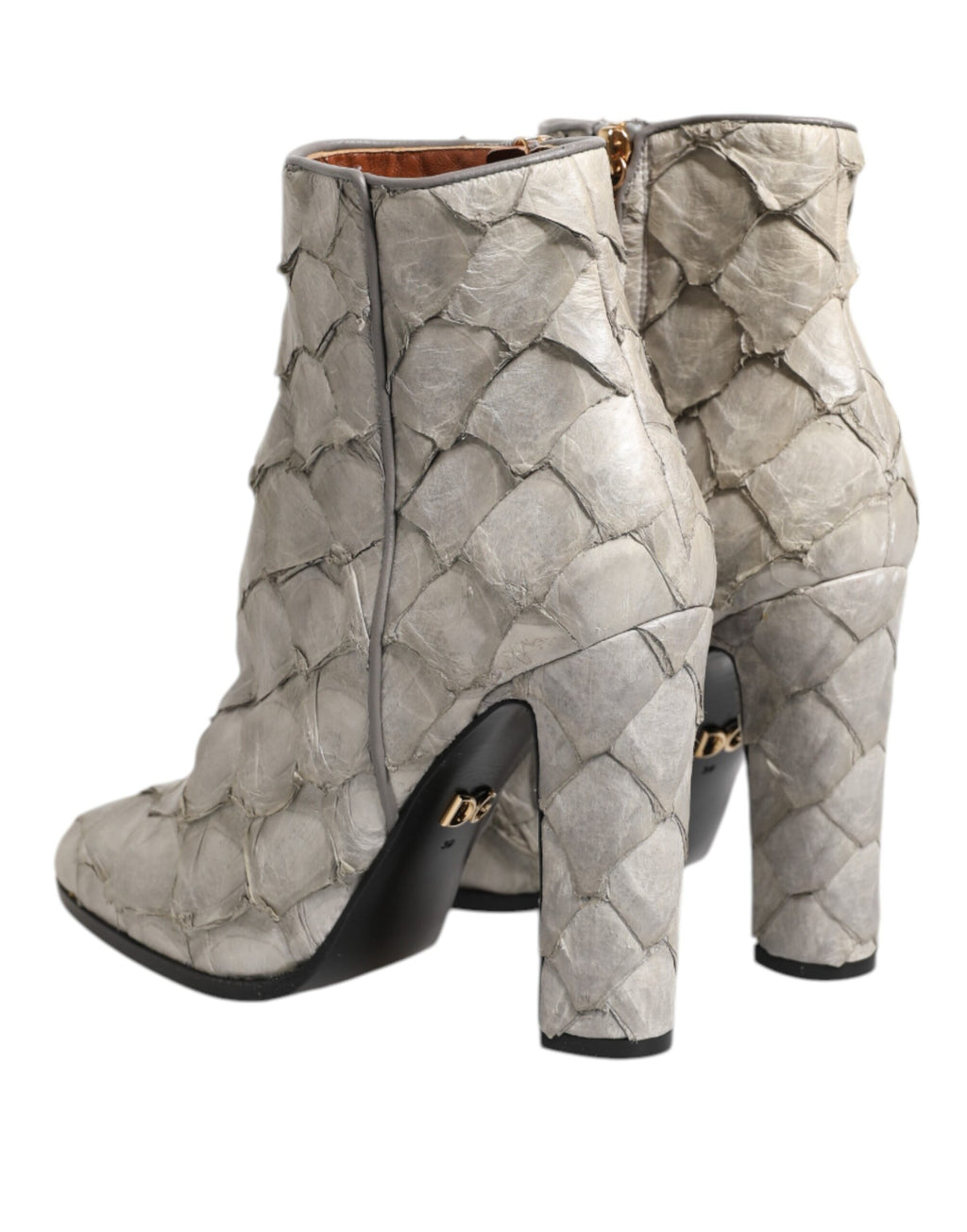 Chaussures Dolce & Gabbana en cuir blanc, talons et bottines à la cheville, élégantes et sophistiquées.