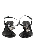 Sandales à talons en cuir noir Dolce & Gabbana avec bride à la cheville ornée de cristaux, élégantes et sophistiquées.