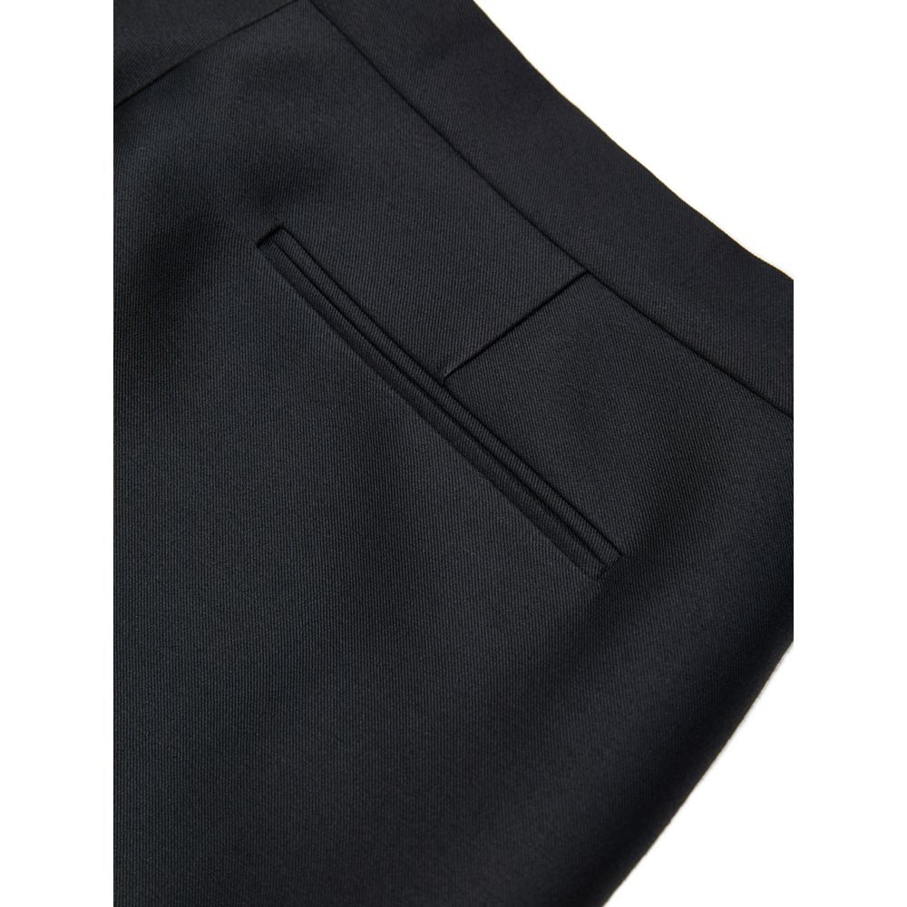 Pantalons décontractés en coton noir de Gucci, style casual, avec coupe droite et logo discret, visibles sur l'image.