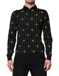 Polo en maille jacquard noir Dolce & Gabbana avec logo, à col classique et manches longues, vue de face.