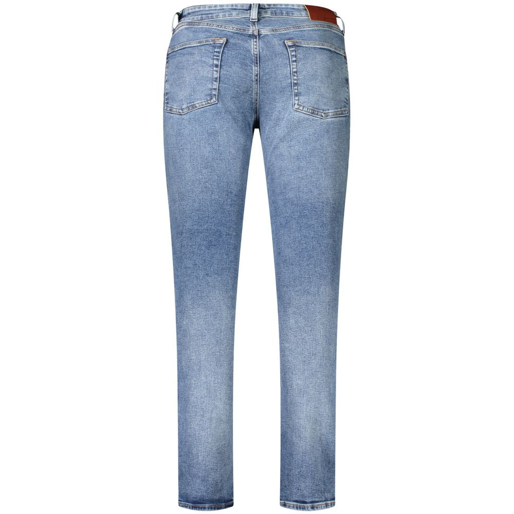 Jeans en coton bleus pour homme de la marque Tommy Hilfiger, coupe classique avec poches avant et arrière, détails en denim.