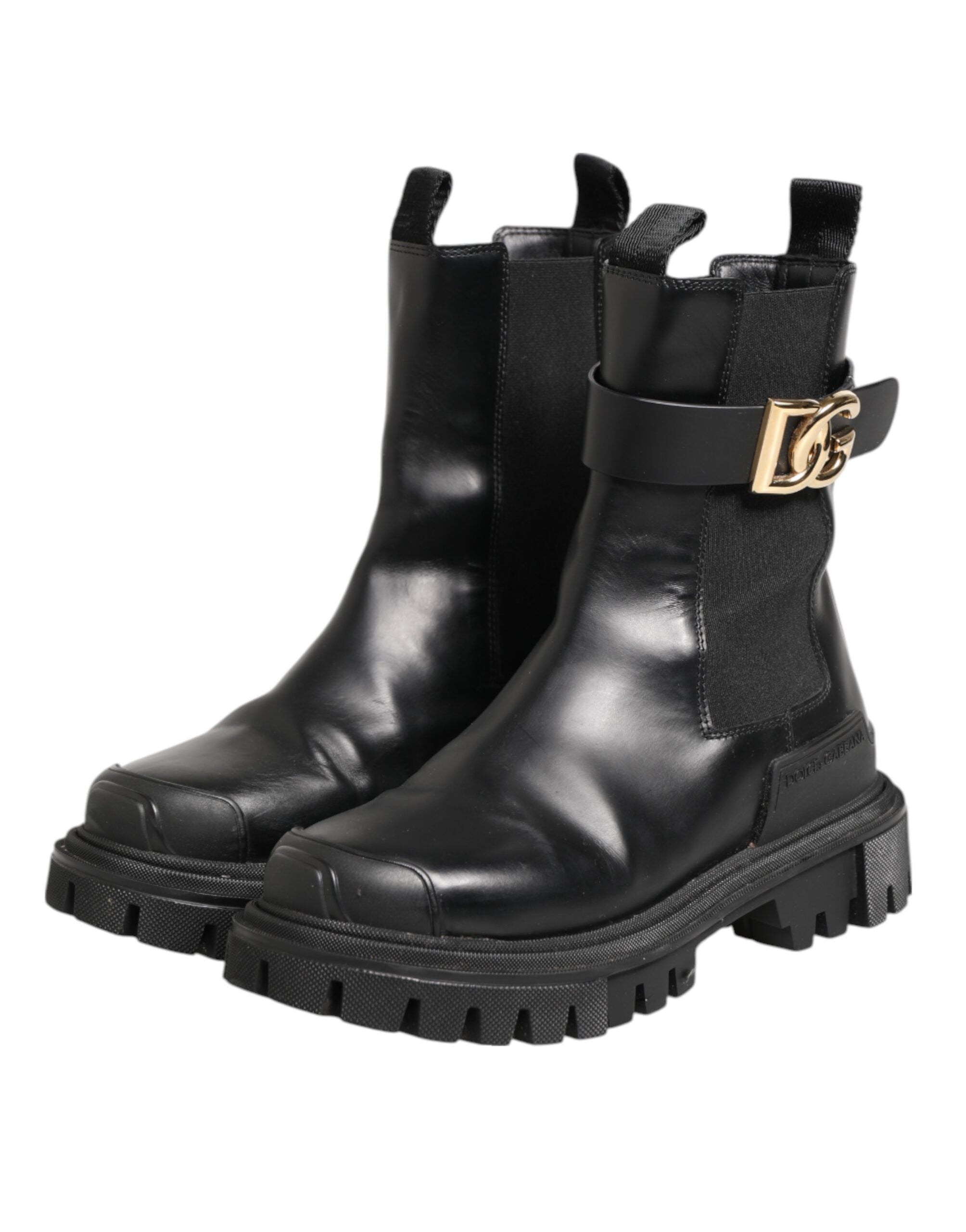 Bottes de randonnée Dolce & Gabbana noires et dorées avec logo DG, style trekking, en cuir, visibles en gros plan.