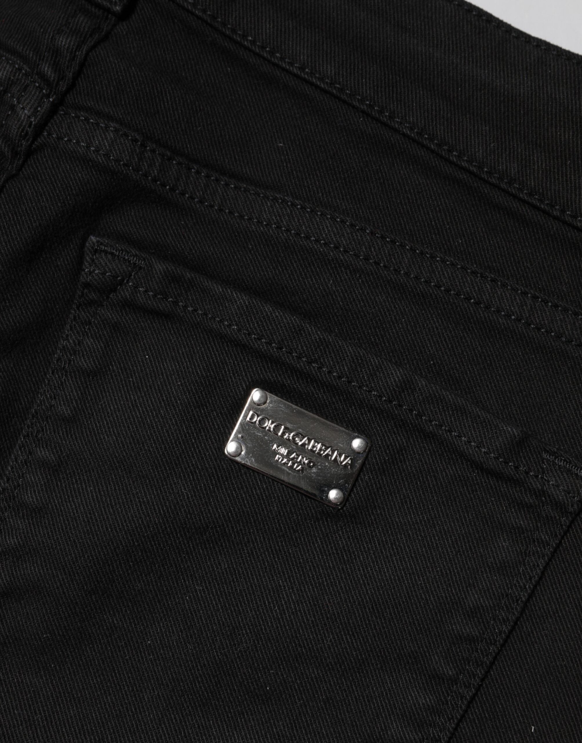 Jeans skinny en coton noir de Dolce & Gabbana, taille mi-haute, mode denim élégante, visibles en gros plan.