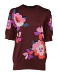 Chemise en soie pour femme Dolce & Gabbana, col rond, motif floral bordeaux, tissu fluide et élégant.