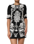 Robe noire en dentelle Dolce & Gabbana à manches courtes et coupe en A, avec finition en dentelle élégante.