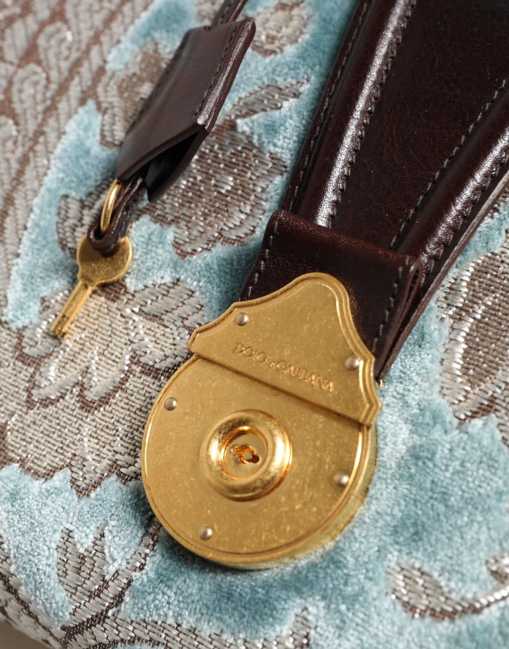 Sac à main de voyage Dolce & Gabbana en cuir bleu et marron avec jacquard floral, élégant et spacieux.