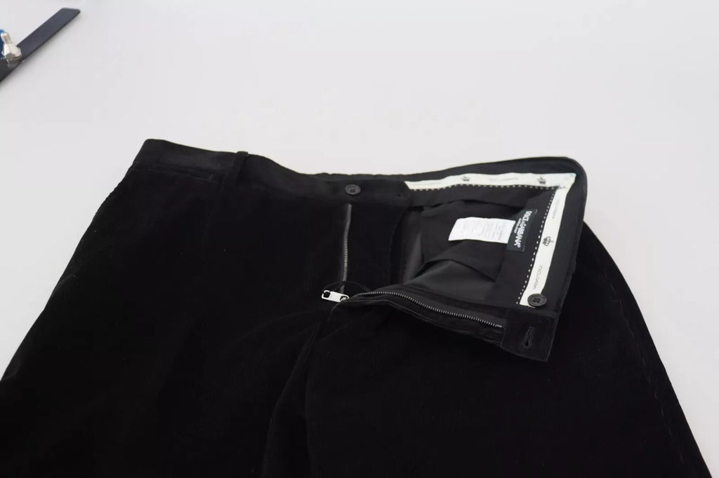 Pantalons chino slim en coton extensible noir de Dolce & Gabbana, vue de face sur un fond blanc.