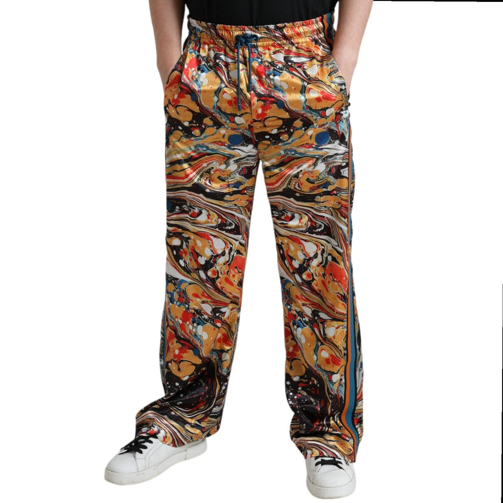 Pantalon satin à imprimé marbre multicolore signé Dolce & Gabbana, style élégant et tendance, vue de face.