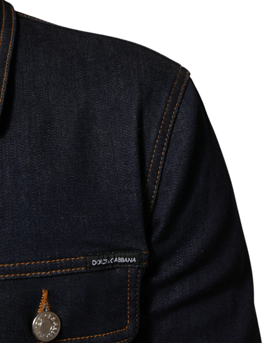 Veste en denim slim fit bleu indigo Dolce & Gabbana avec logo et patch, style élégant et décontracté.