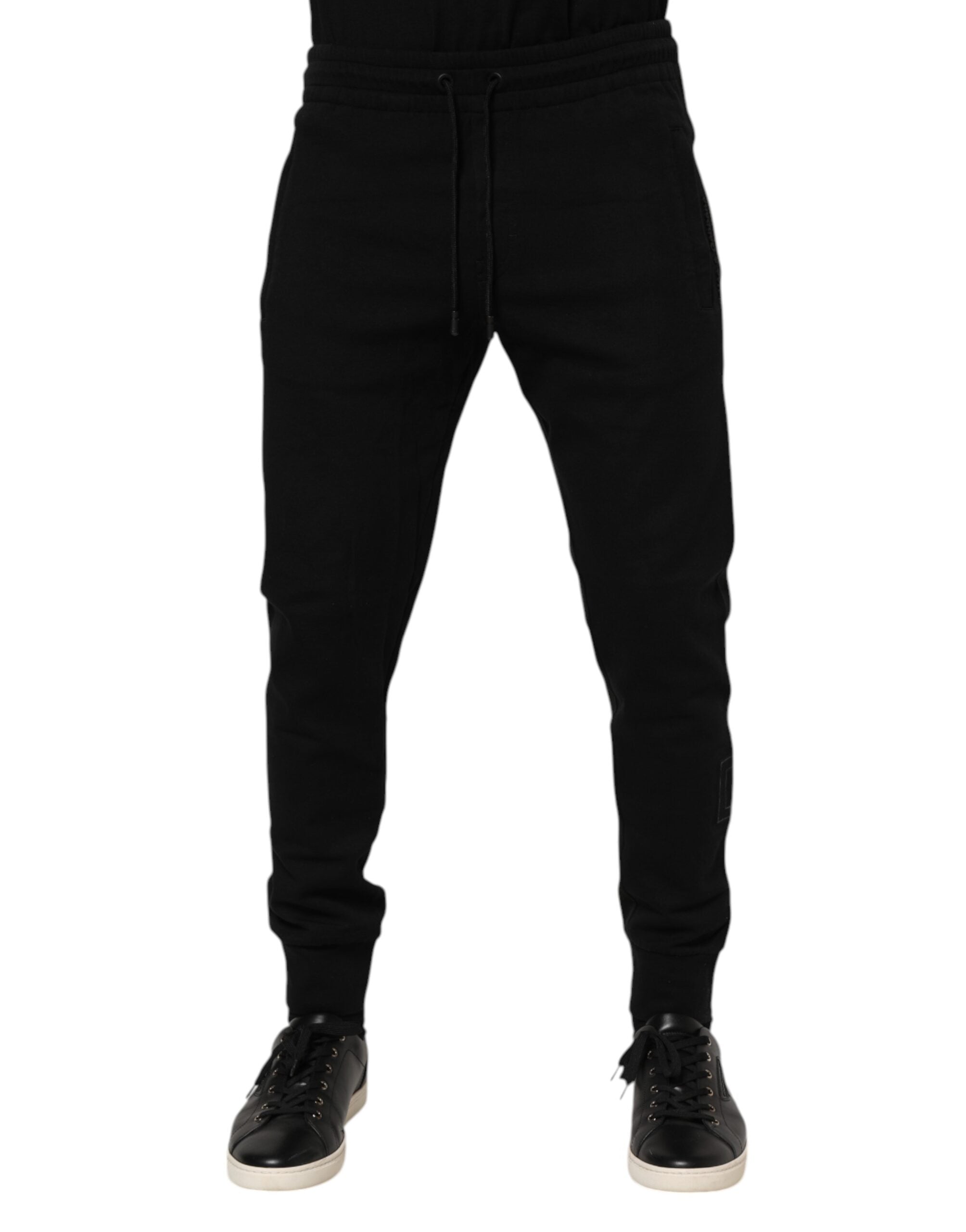 Pantalon de jogging noir en coton Dolce & Gabbana pour hommes, style décontracté avec ceinture élastique et poches latérales.