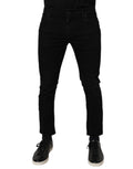 Jeans slim en coton noir Dolce & Gabbana pour homme, pantalon ajusté avec ceinture et poches visibles.