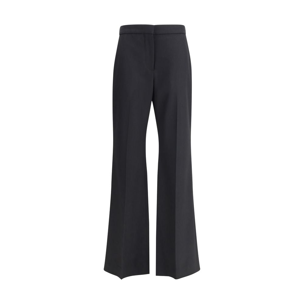Pantalon en laine noire Givenchy Oves Aries avec coupe élégante et détails modernes, porté en situation décontractée.