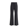 Pantalon en laine noire Givenchy Oves Aries avec coupe élégante et détails modernes, porté en situation décontractée.