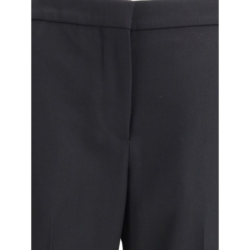 Pantalon en laine noire Givenchy Oves Aries, coupe élégante, tissu texturé, porté par un mannequin.