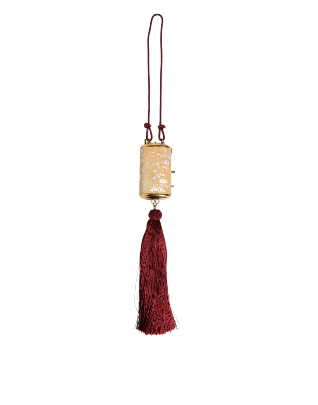 Sac Dolce & Gabbana blanc en résine perle, or métal, avec pendentif à franges rouges et détails élégants.