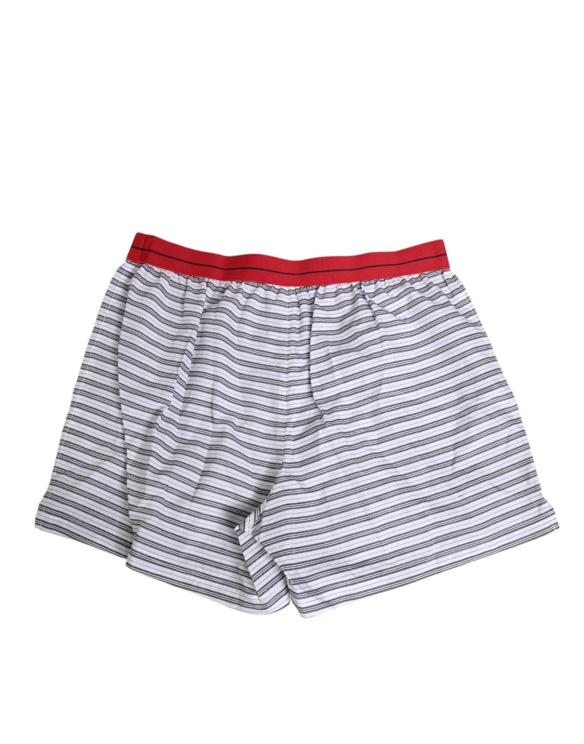 Shorts de bain Dolce & Gabbana en coton blanc à rayures, avec ceinture rouge, style maillot de bain décontracté et élégant.