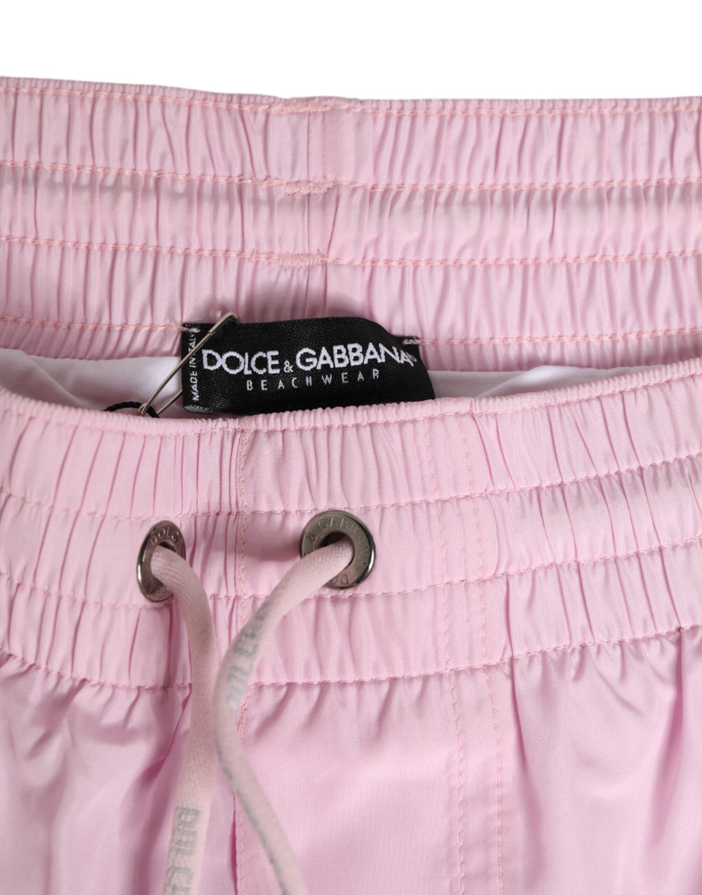Maillot de bain homme Dolce & Gabbana en nylon rose avec logo et rayures latérales, parfait pour la plage.