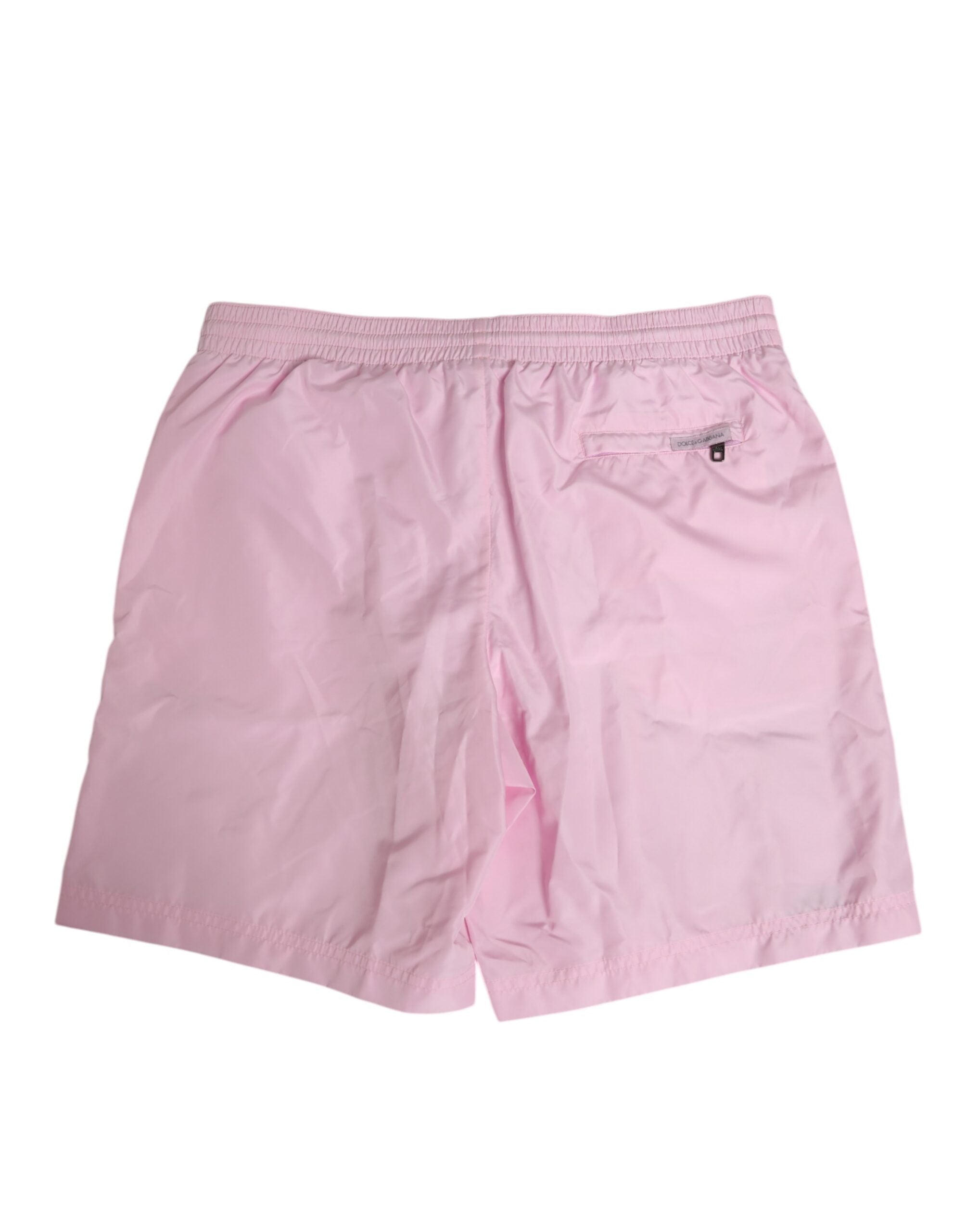 Maillot de bain homme Dolce & Gabbana en nylon rose avec logo et bandes latérales, style beachwear élégant.