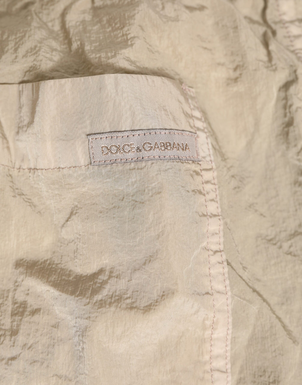 Boxers de bain hommes Dolce & Gabbana en nylon beige, maillot de plage léger et confortable pour la baignade.