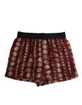 Short de bain homme Dolce & Gabbana en soie bordeaux avec imprimé pièces de monnaie, coupe confortable et élégant.