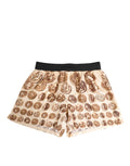Shorts de bain en soie Dolce & Gabbana à motif de pièces de monnaie anciennes marron, style élégant et luxueux.
