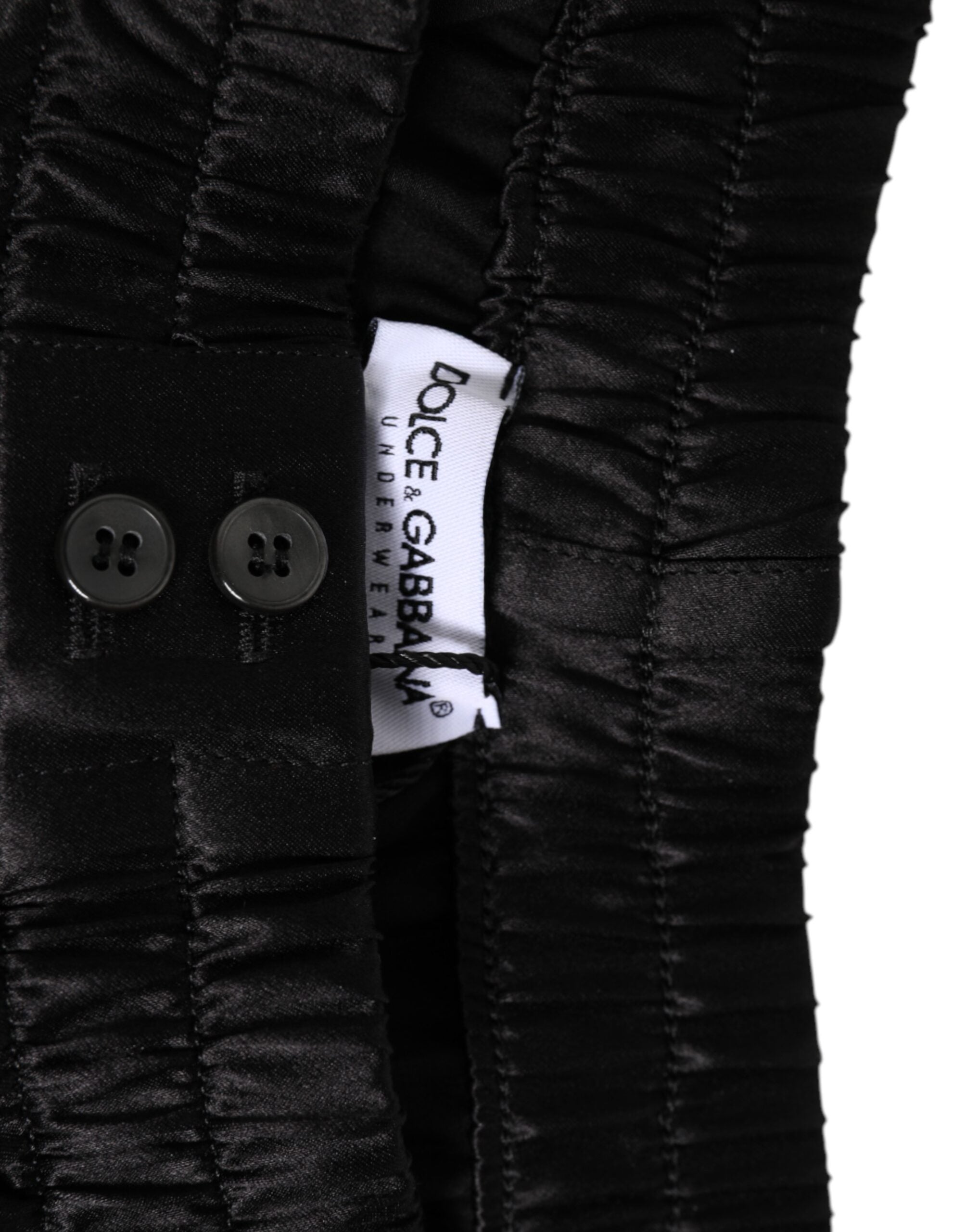 Boxers homme en satin de soie noir Dolce & Gabbana, short de bain élastique avec logo Dolce & Gabbana visible.