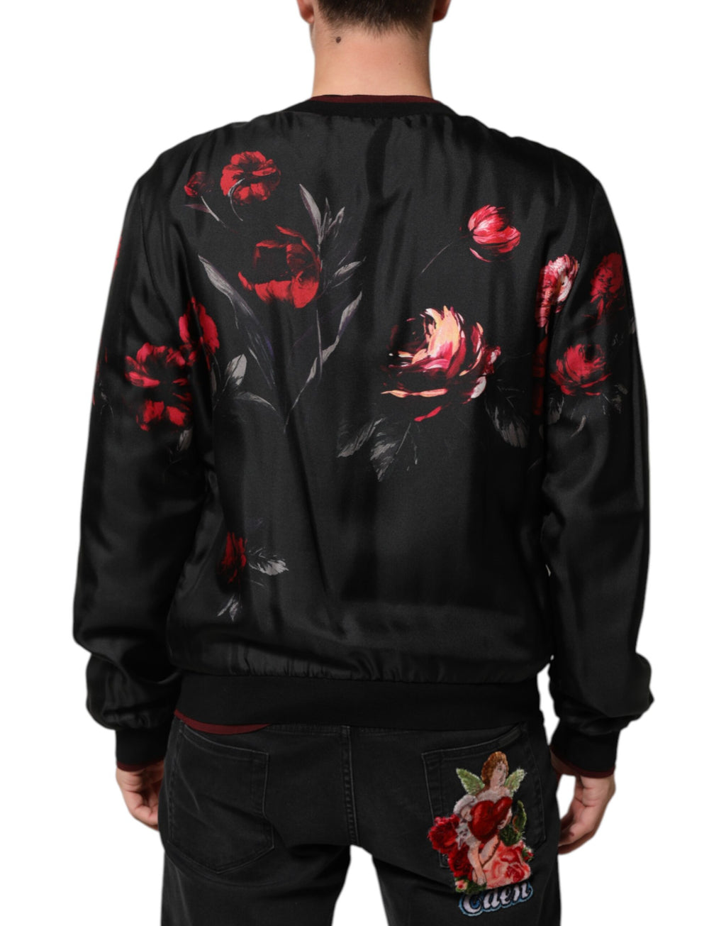 Veste bomber en soie noire et rouge à fleurs Dolce & Gabbana, style élégant et tissu fluide visible sur l'image.