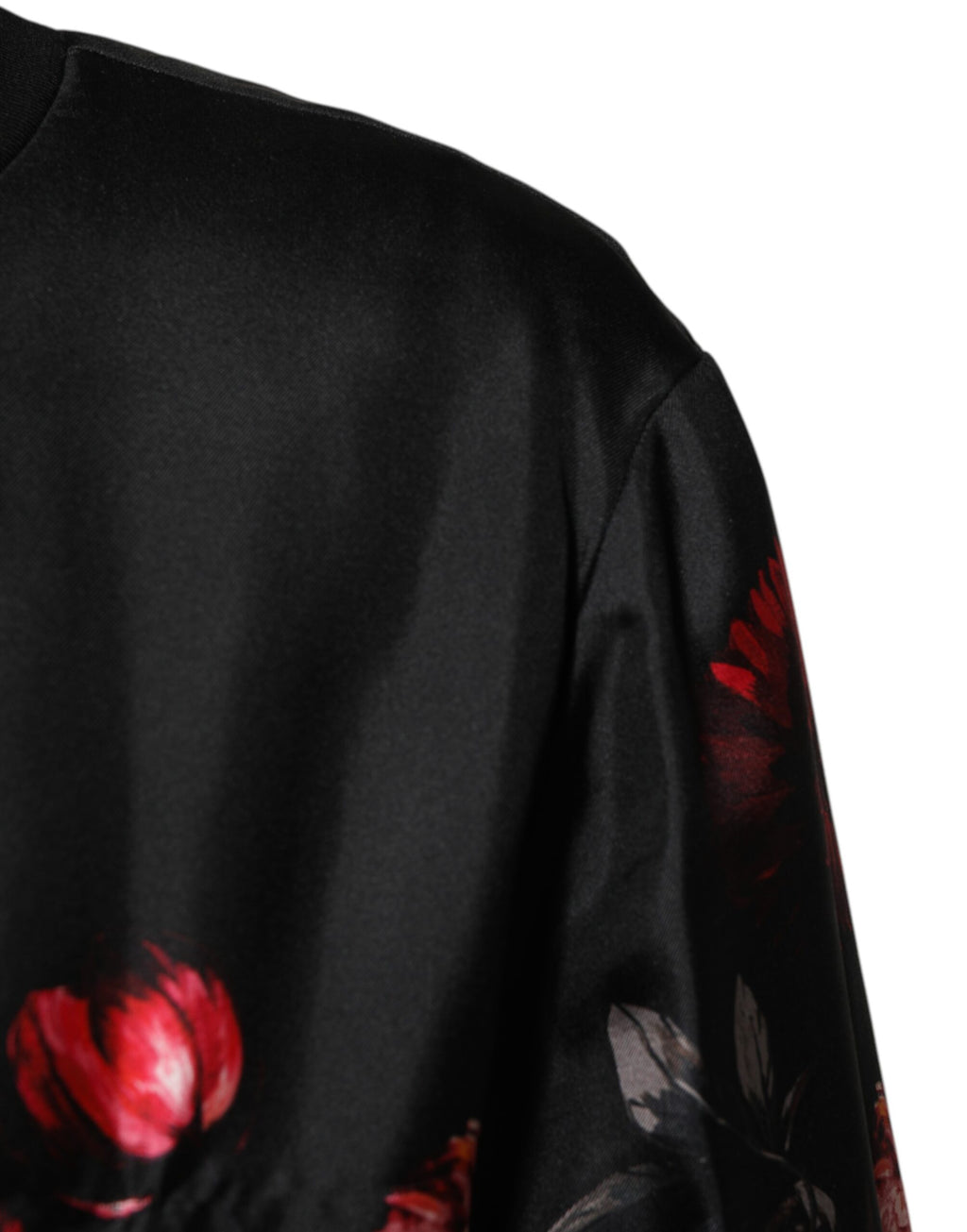 Veste bomber en soie noire et rouge à fleurs Dolce & Gabbana, style élégant avec détails floraux.
