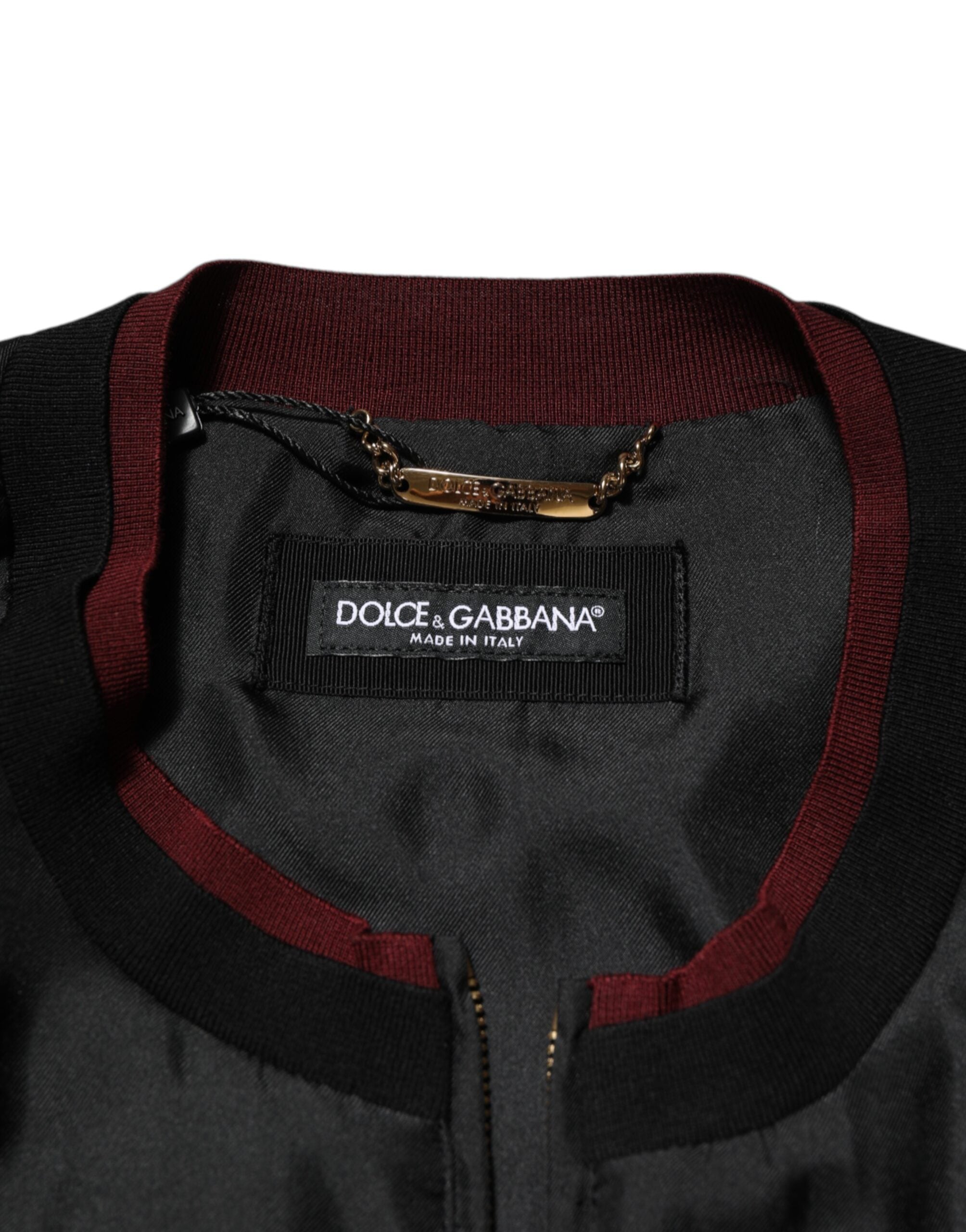 Veste bomber en soie noire et rouge à fleurs Dolce & Gabbana, style élégant avec motif floral sophistiqué.