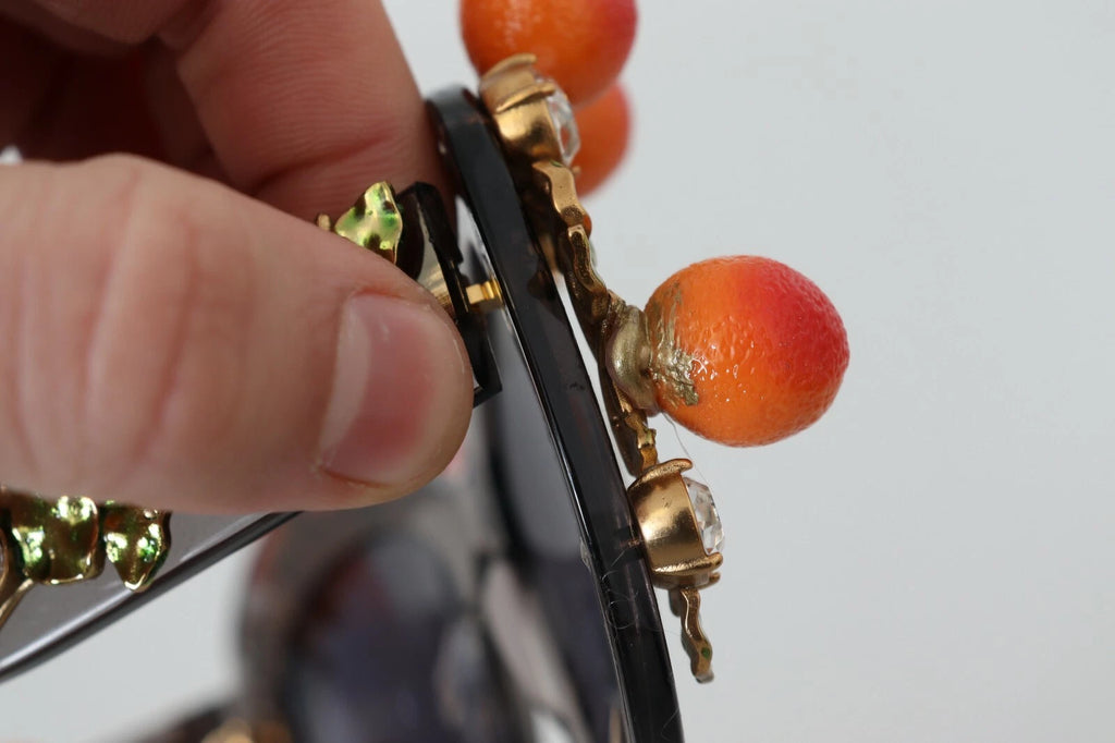 Lunettes de soleil Dolce & Gabbana DG4283B en acétate avec cristaux orange et appliques ornementales, style élégant et sophistiqué.