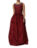 Robe de soirée en soie bourgogne Dolce & Gabbana ornée de perles, longue et élégante, portée lors d'événements formels.